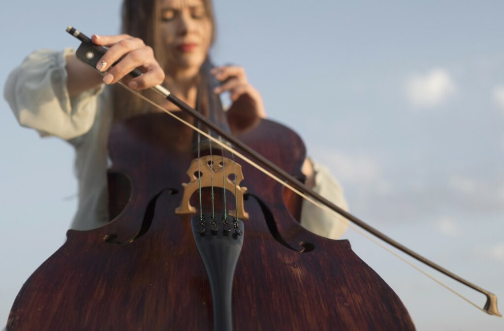 Une violoncelliste en train de jouer de son instrument.